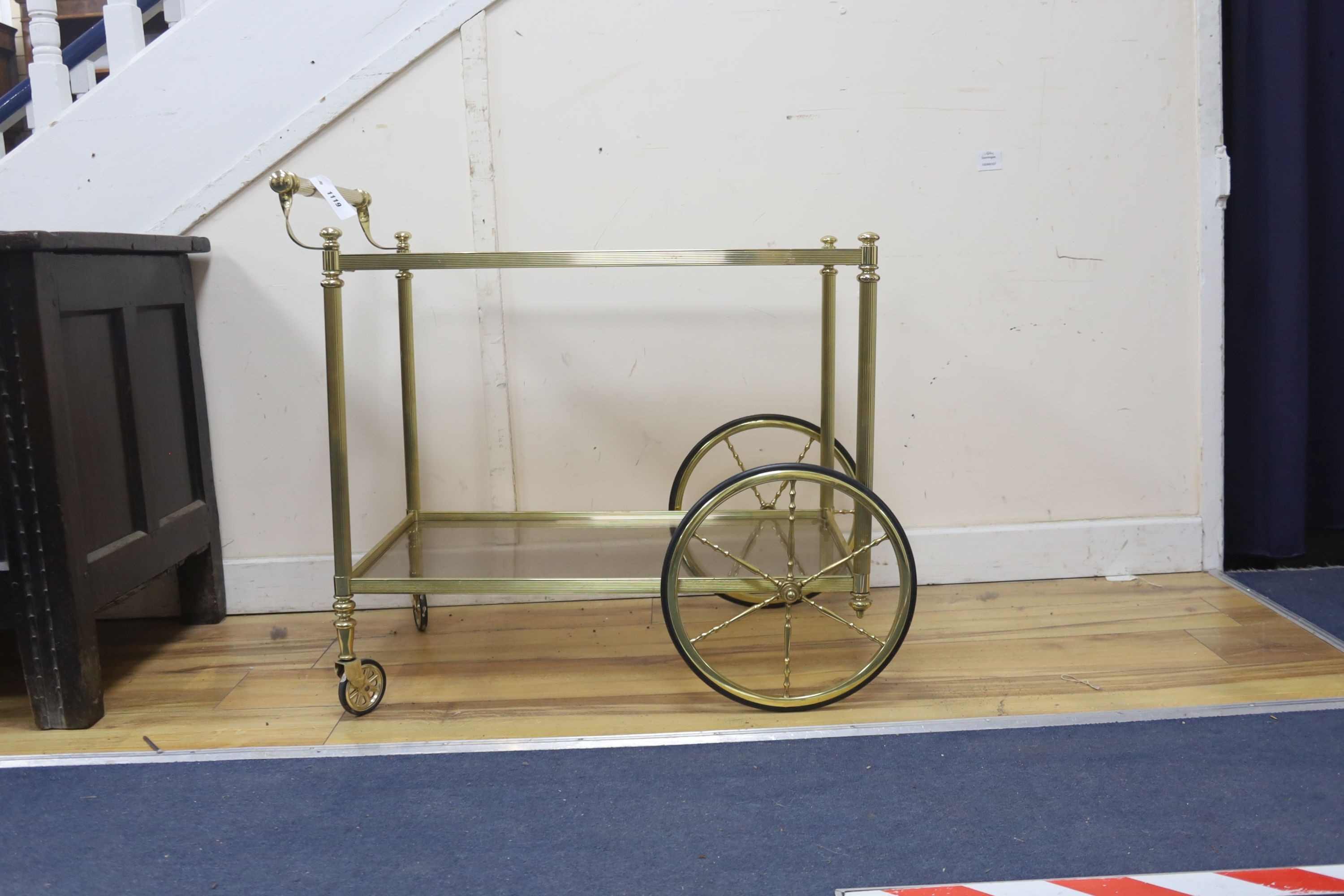 A Hollywood Regency brass and glass two tier drinks trolley, width 74cm, depth 44cm, height 70cm